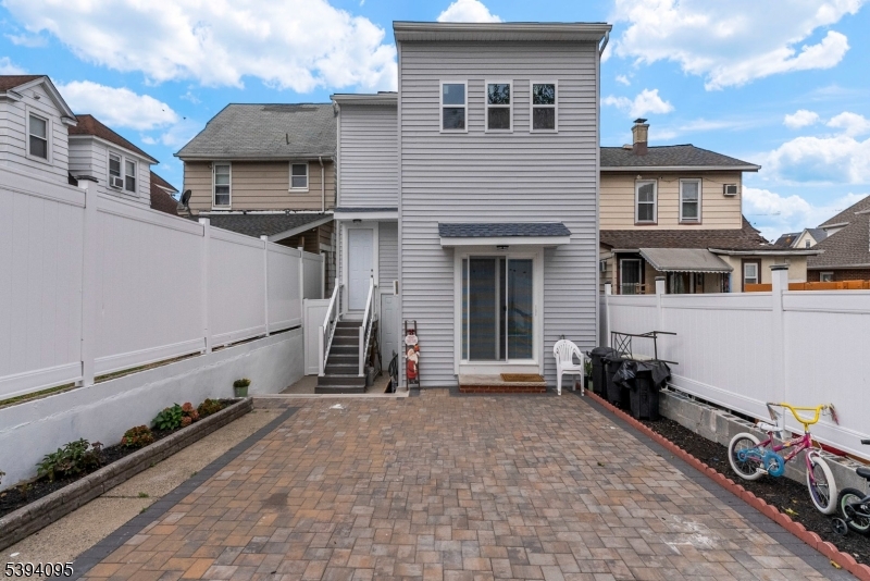 1033 East 23rd Street, Unit 2 Paterson, NJ 07513 - Photo 21 of 21 a view of a house with a wooden fence