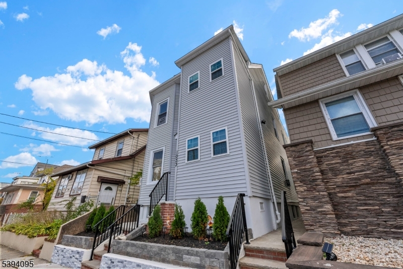 1033 East 23rd Street, Unit 2 Paterson, NJ 07513 - Photo 3 of 21 a front view of a house with street