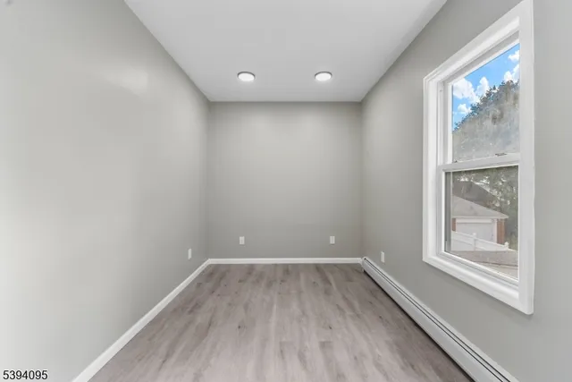 a view of a room with wooden floor and windows