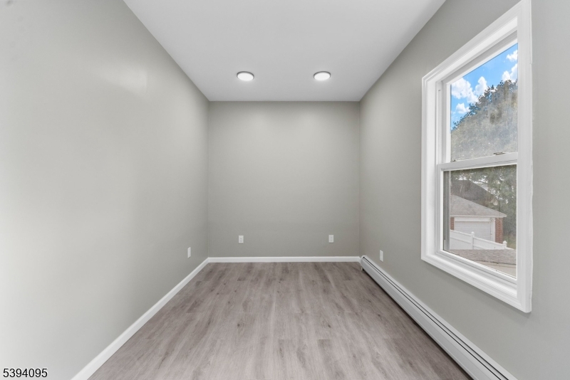 1033 East 23rd Street, Unit 2 Paterson, NJ 07513 - Photo 8 of 21 a view of a room with wooden floor and windows