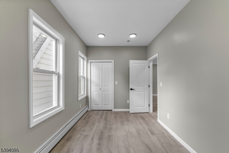 1033 East 23rd Street, Unit 2 Paterson, NJ 07513 - Photo 9 of 21 wooden floor in an empty room with a window