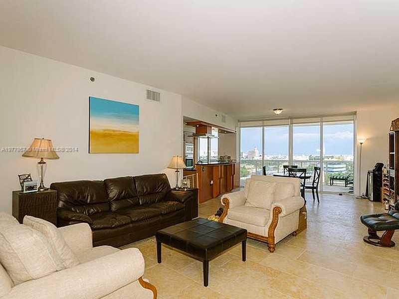 400 Alton Road, Unit 1011 Miami Beach, FL 33139 - Photo 3 of 13 a living room with furniture and a table with potted plants