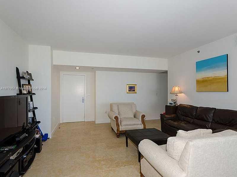 400 Alton Road, Unit 1011 Miami Beach, FL 33139 - Photo 4 of 13 a living room with furniture a flat screen tv and gym equipment