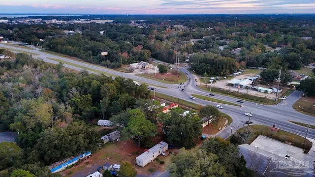 an aerial view of a house with garden space and street view
