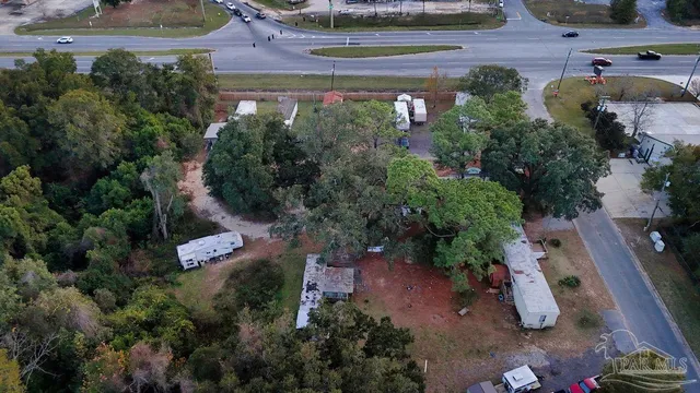 an aerial view of a house with a yard and garden