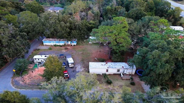 an aerial view of a house with a yard basket ball court