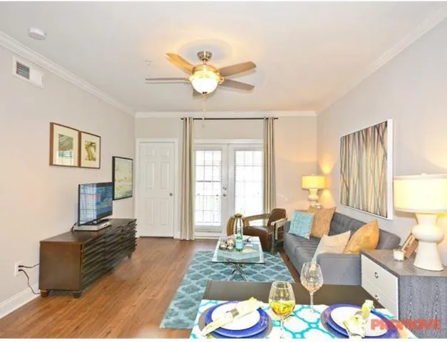 a living room with furniture and a large window