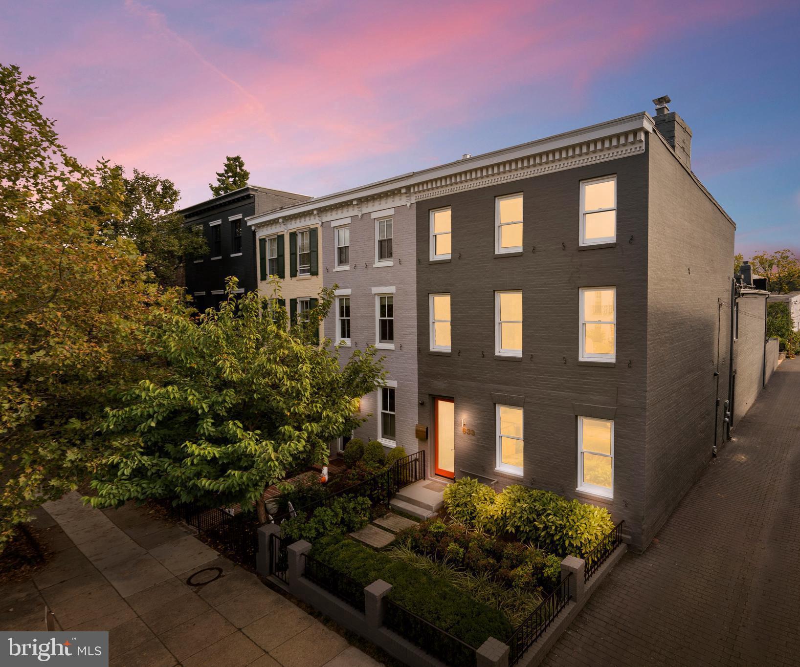 a front view of a house with garden