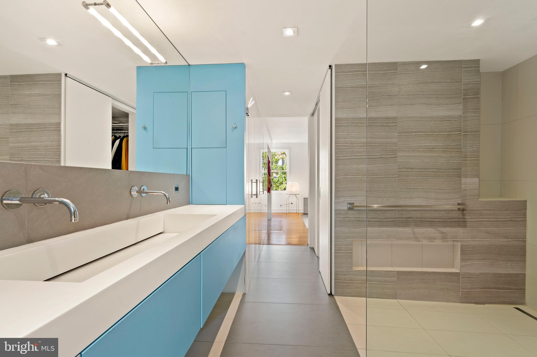 633 E Street Southeast Washington, DC 20003 - Photo 29 of 52 a bathroom with a double vanity sink a large mirror and shower