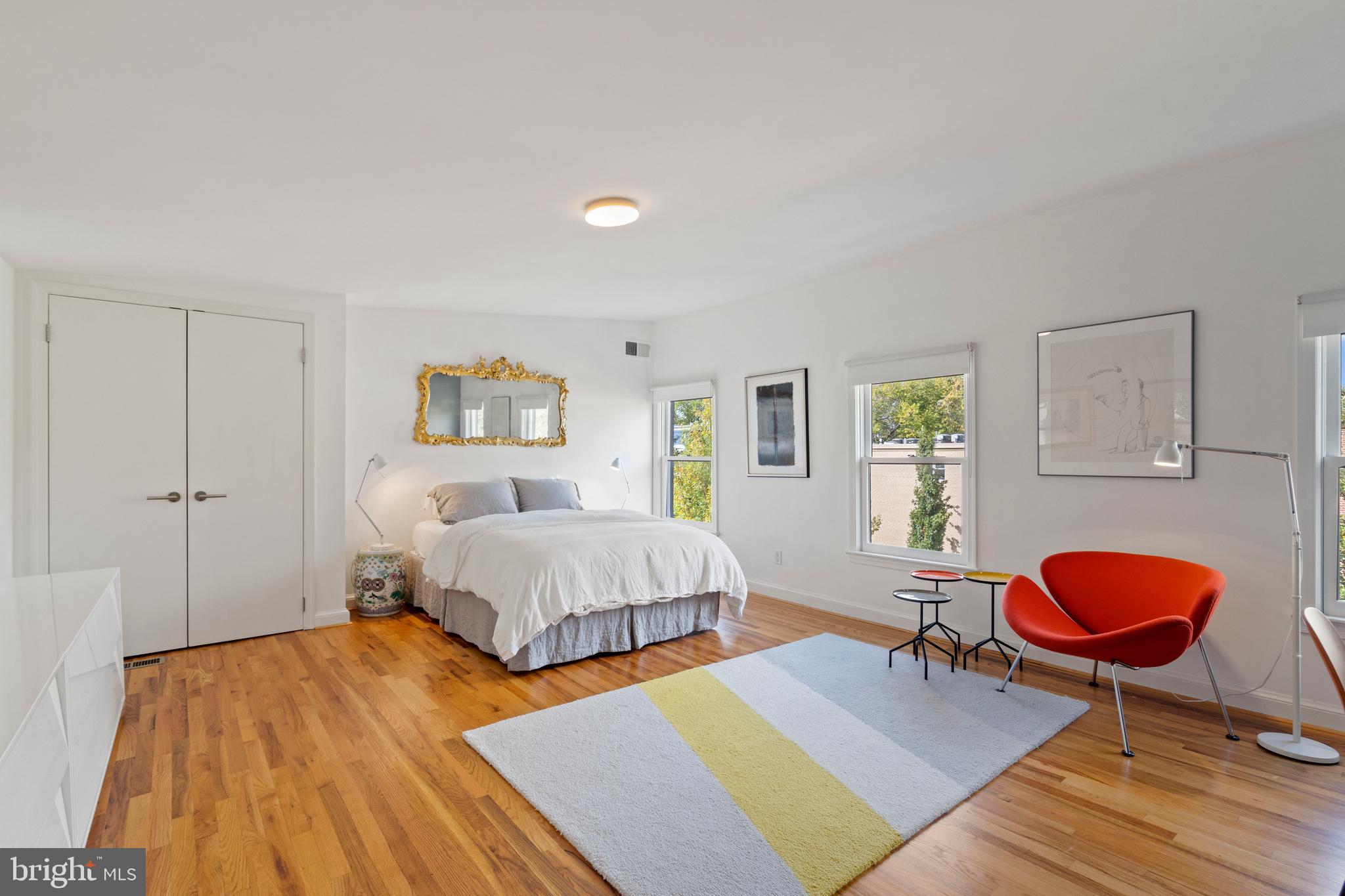 633 E Street Southeast Washington, DC 20003 - Photo 38 of 52 a spacious bedroom with a bed a table and a dresser next to a window