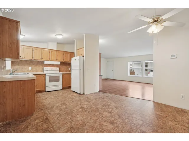 a view of kitchen with refrigerator and window