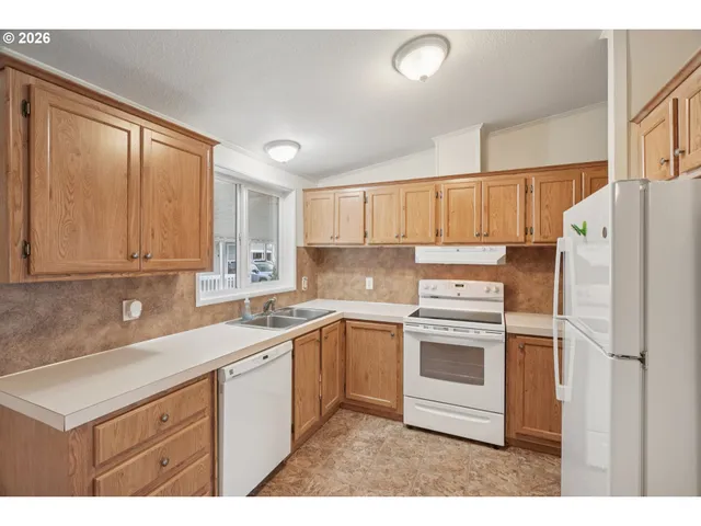 a kitchen with a sink stove and refrigerator