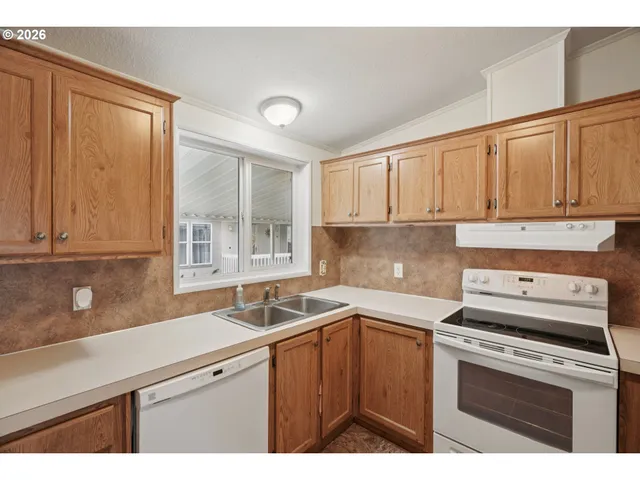 a kitchen with a sink cabinets and window