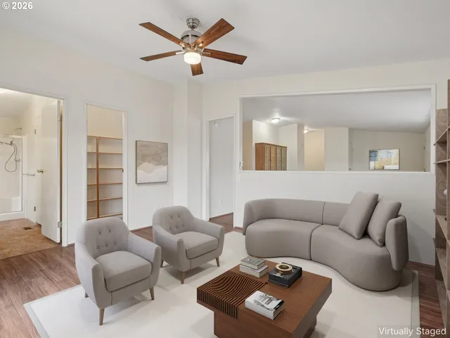 a living room with furniture and a large mirror
