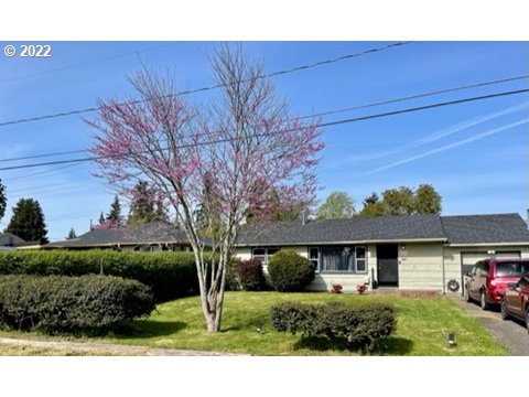 3165 Pheasant Boulevard Springfield, OR 97477 - Photo 2 of 2 a view of a big house with a big yard and potted plants