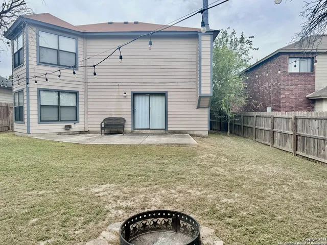 a view of a house with a backyard