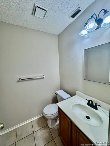 a bathroom with a sink mirror and toilet