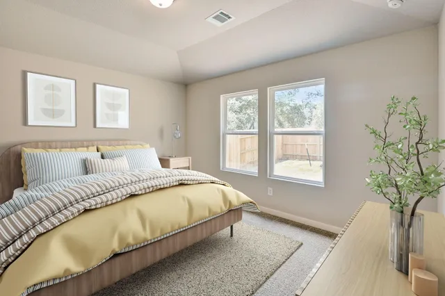 a spacious bedroom with a bed and a window