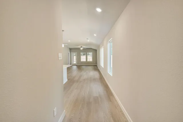 a view of gallery with wooden floor