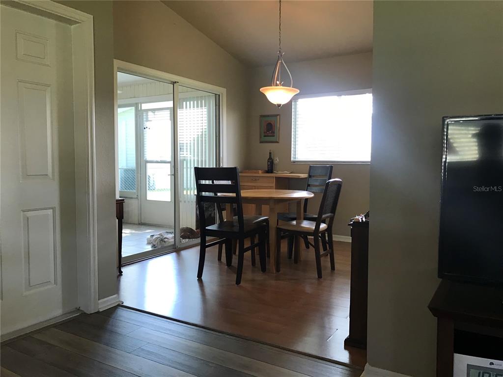 11879 Southwest 137th Loop Dunnellon, FL 34432 - Photo 13 of 37 a view of a dining room with furniture window and wooden floor