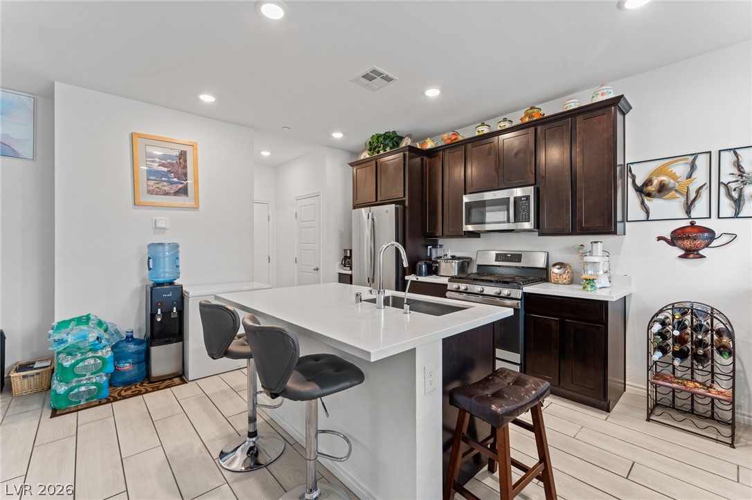 8879 Roadrunner Ravine Street Las Vegas, NV 89166 - Photo 11 of 39 Clean lines and a spacious kitchen island define this contemporary culinary space.