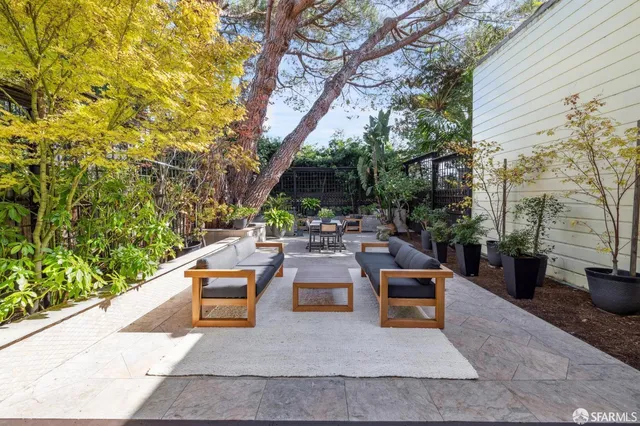 a view of outdoor dining space with a table and chairs