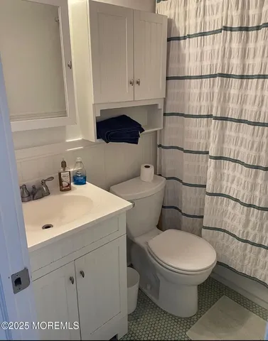 a white toilet sitting next to a bathroom sink