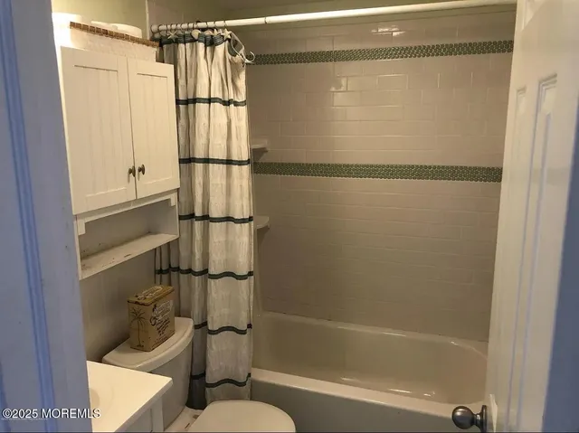 a bathroom with a shower and a toilet