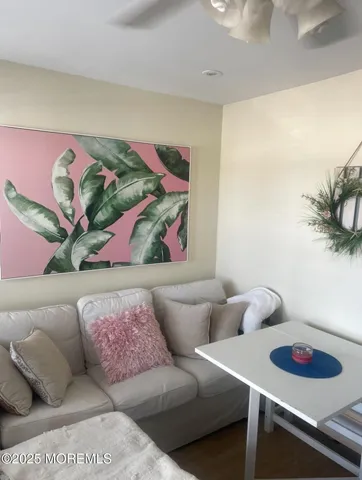 a living room with furniture and painting on the wall