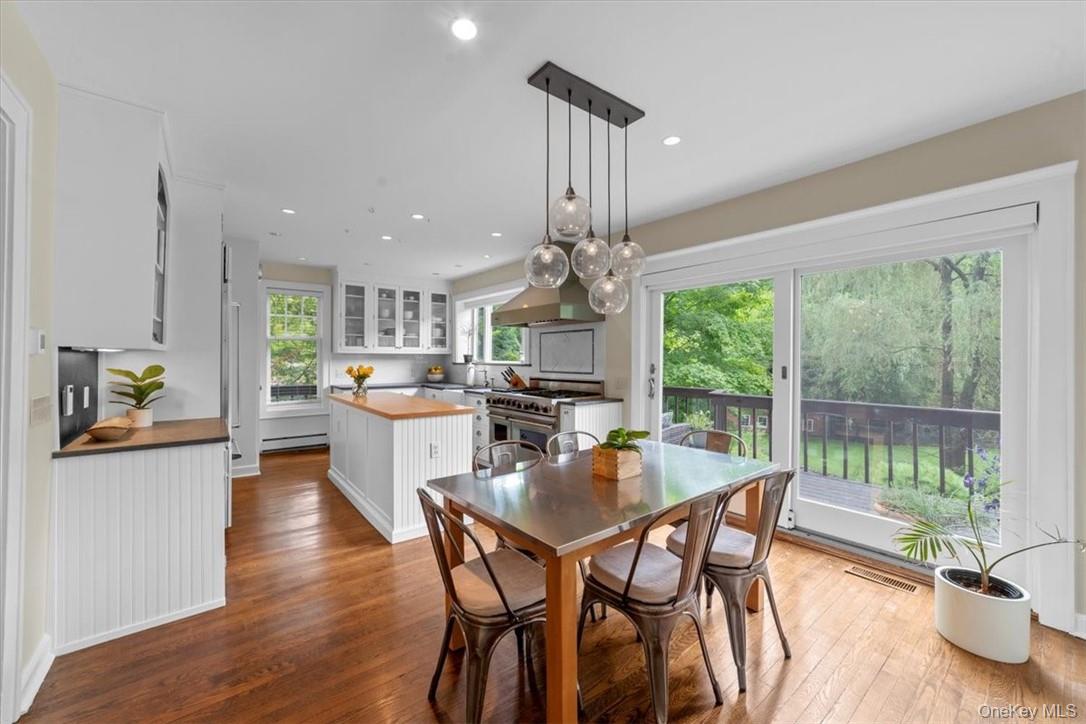 28 Inningwood Road Ossining, NY 10562 - Photo 14 of 37 Dining space featuring sink, a baseboard heating unit, and hardwood / wood-style floors