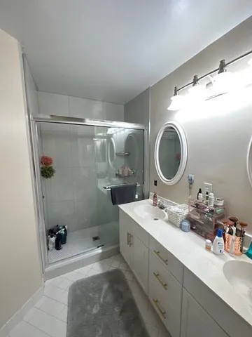 a bathroom with a sink mirror vanity and toilet