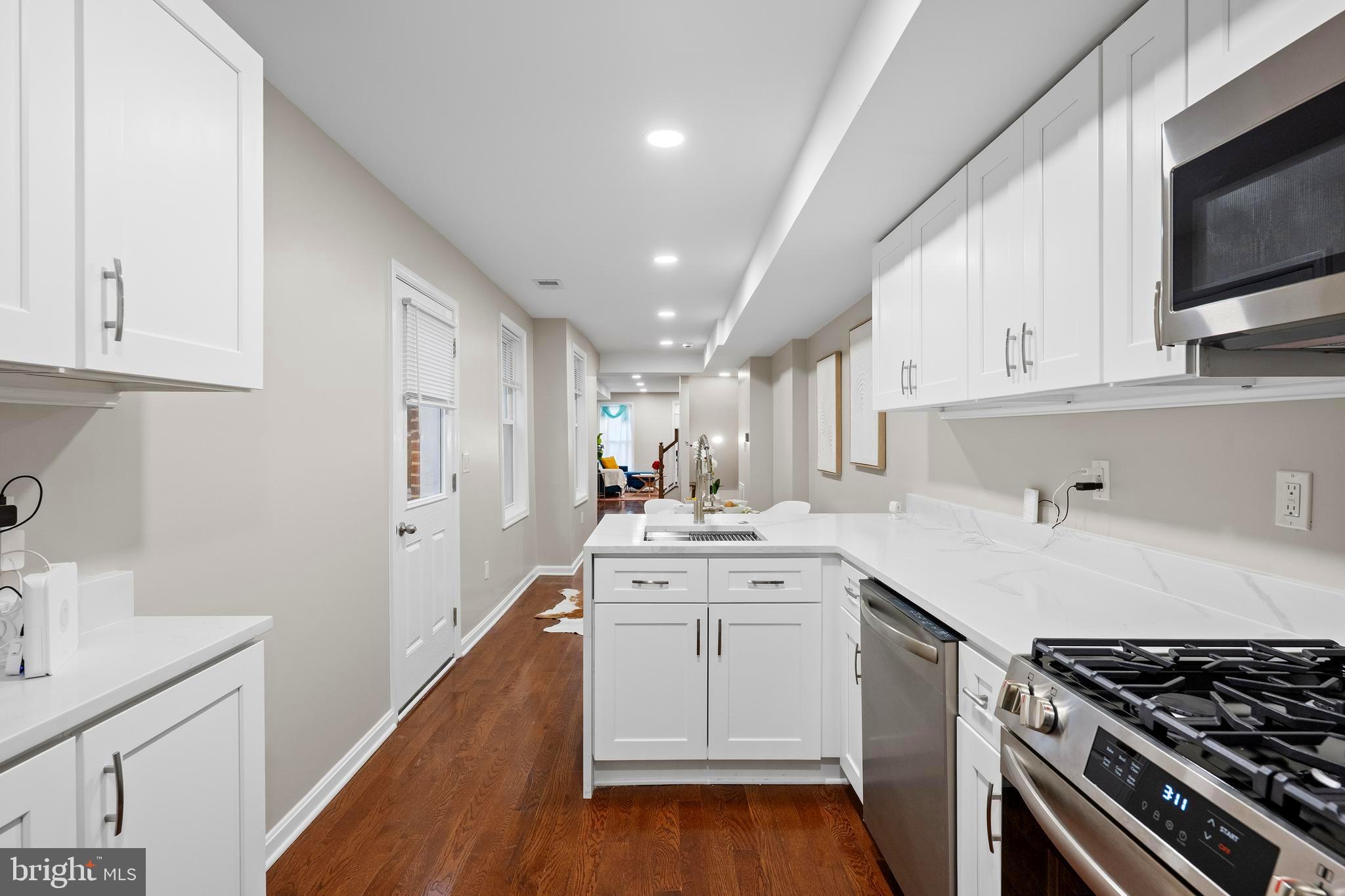 1358 Towson Street Baltimore, MD 21230 - Photo 14 of 51 a kitchen with a sink stove and cabinets