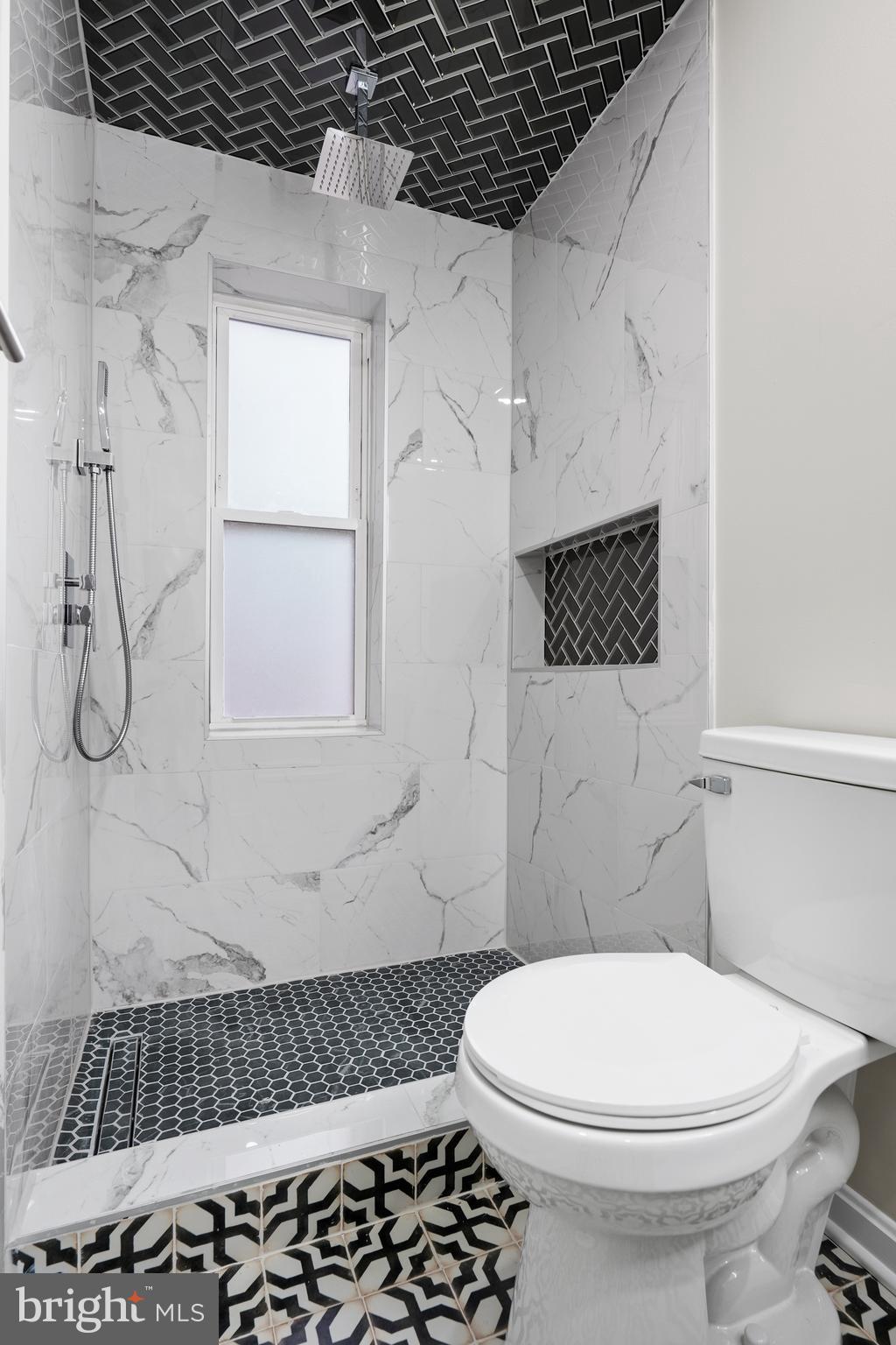 1358 Towson Street Baltimore, MD 21230 - Photo 23 of 51 a bathroom with a toilet a sink and a window