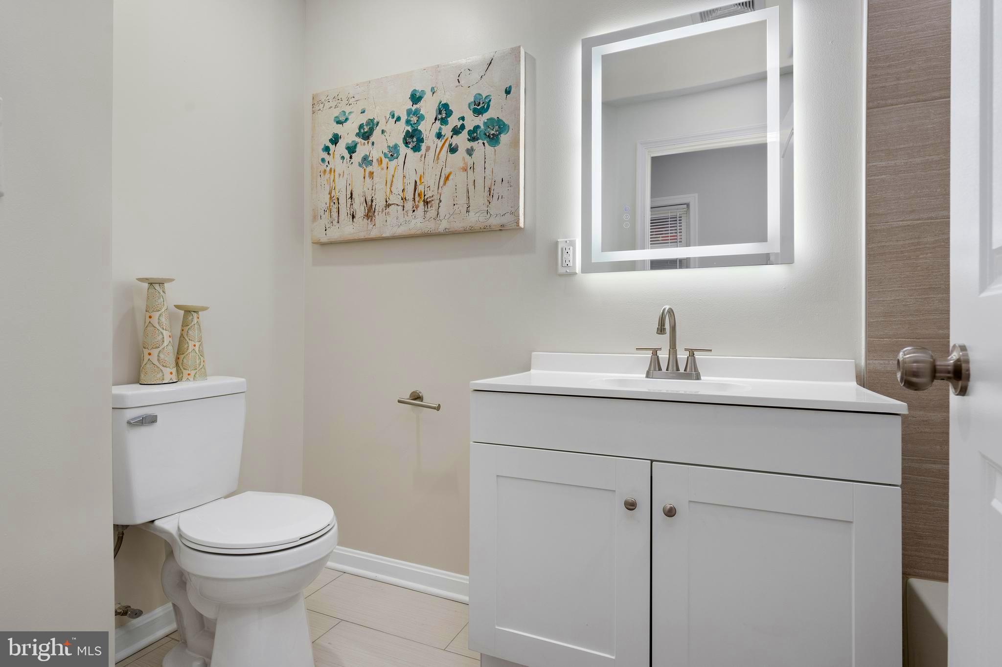 1358 Towson Street Baltimore, MD 21230 - Photo 36 of 51 a bathroom with a toilet sink and mirror
