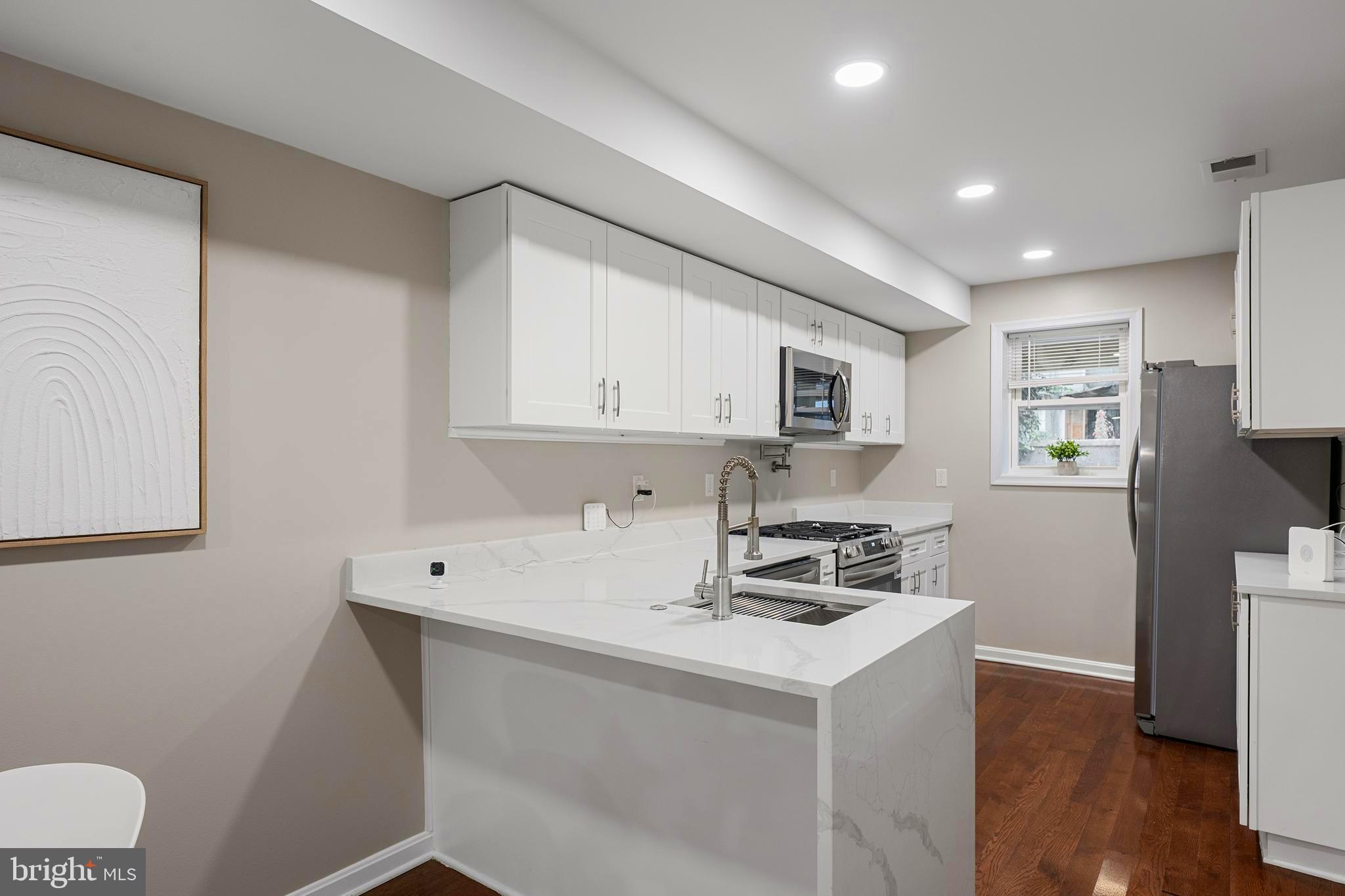 1358 Towson Street Baltimore, MD 21230 - Photo 10 of 51 a kitchen with cabinets a sink and appliances