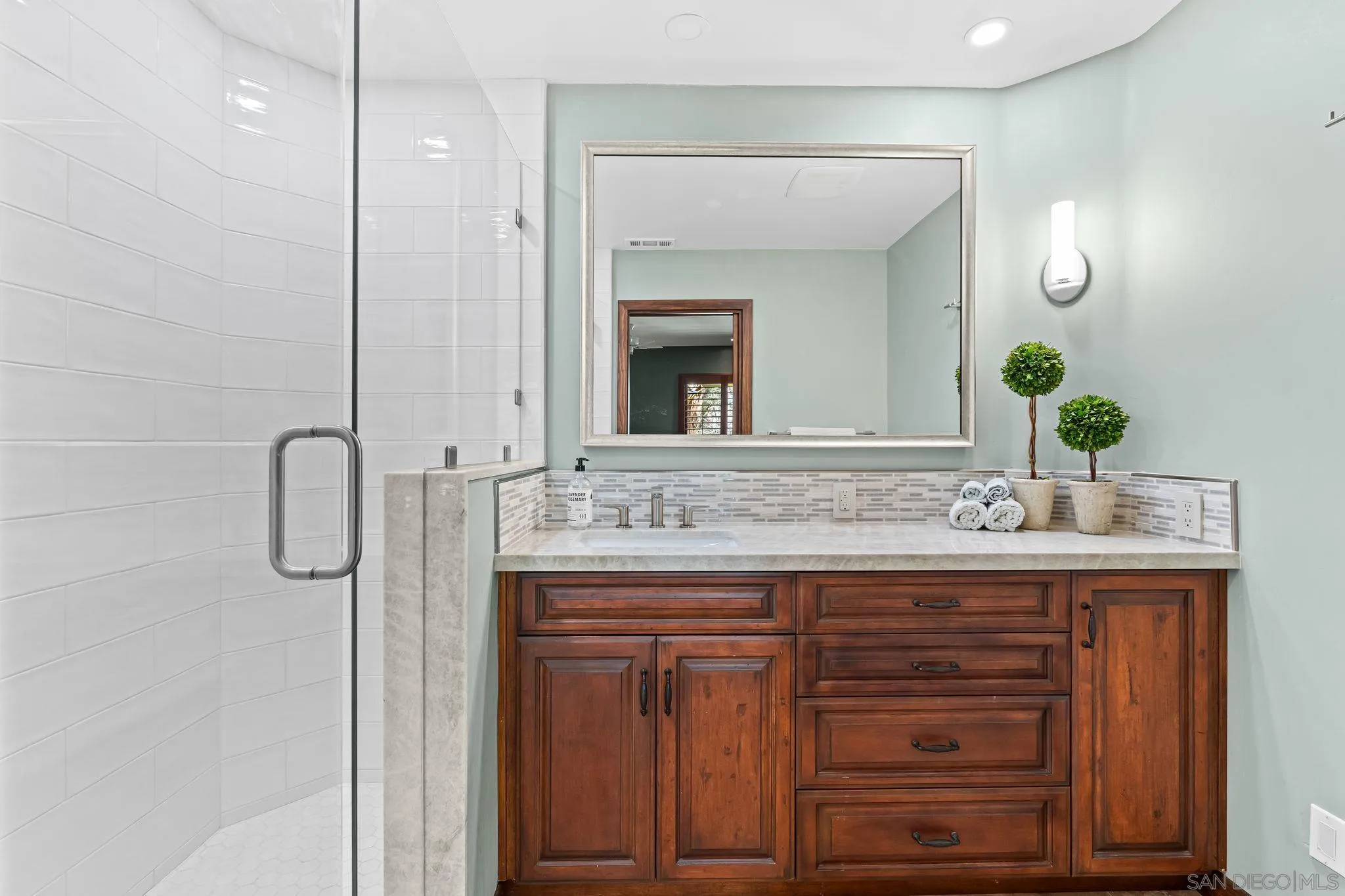 2969 Racetrack View Drive Del Mar, CA 92014 - Photo 34 of 59 a bathroom with a granite countertop sink and a mirror