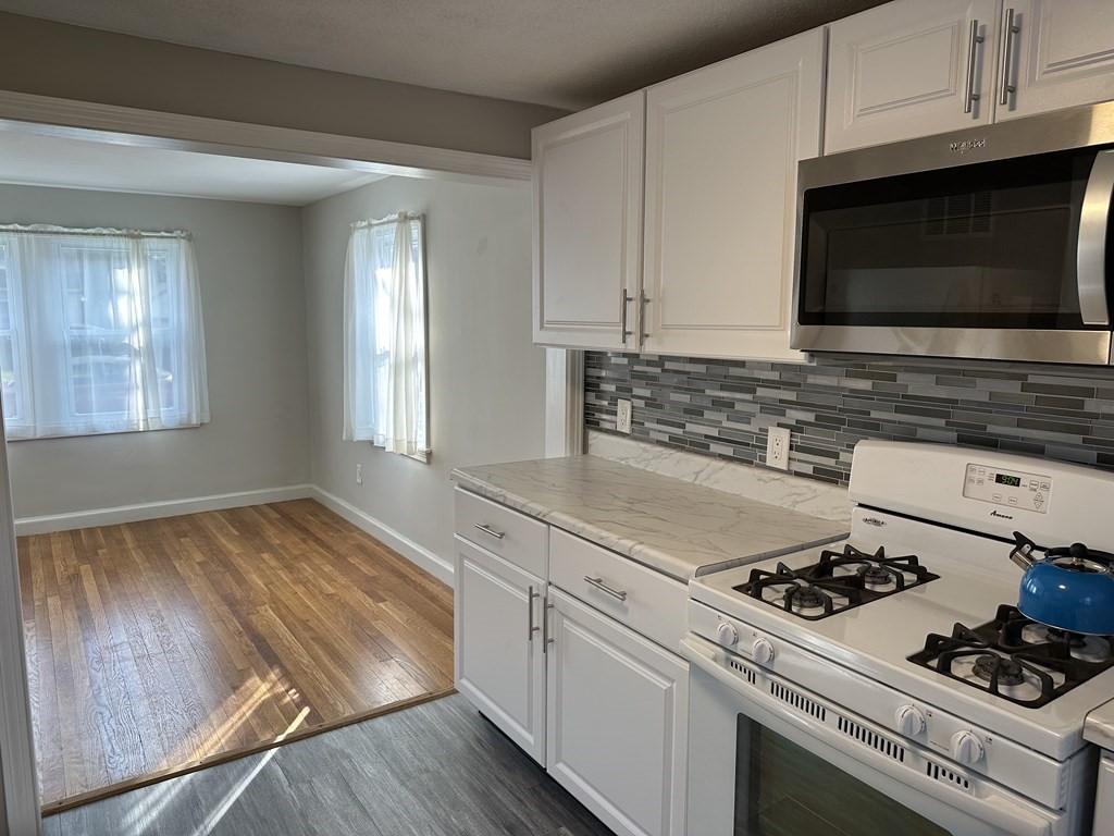 20 Eames Street North Reading, MA 01864 - Photo 7 of 13 a kitchen with a stove and a microwave