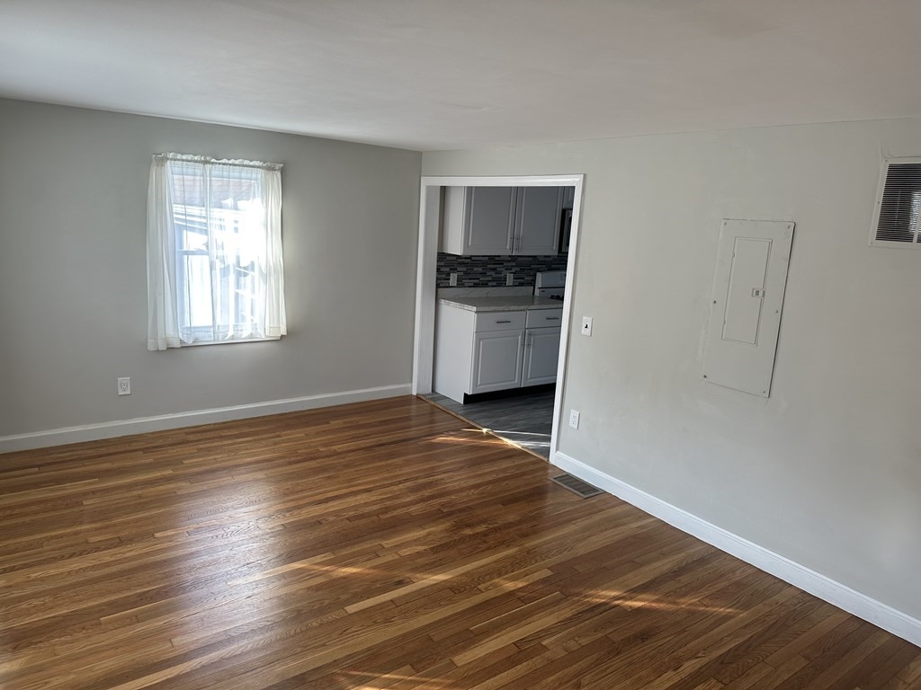 20 Eames Street North Reading, MA 01864 - Photo 8 of 13 a view of empty room with kitchen and window