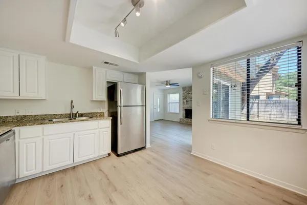 a kitchen with sink and refrigerator