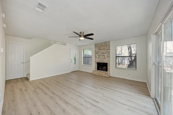 wooden floor in an empty room with a fireplace