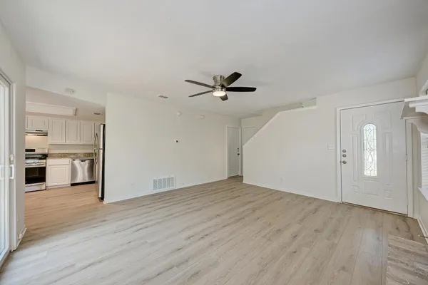 a view of a livingroom with a hardwood floor and a ceiling fan