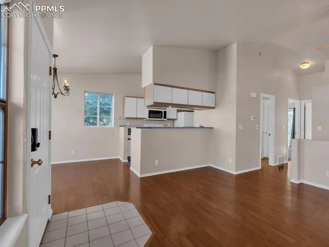 a view of kitchen with furniture and wooden floor