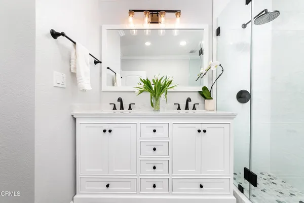 a bathroom with a sink vanity and mirror