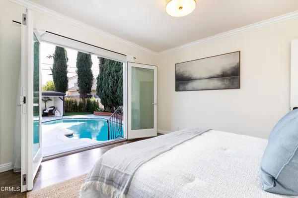 a bedroom with a bed and a view of living room