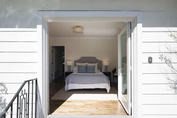 a bedroom with a bed and a window