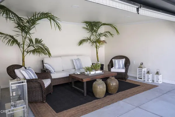 a view of a livingroom with furniture and a potted plant