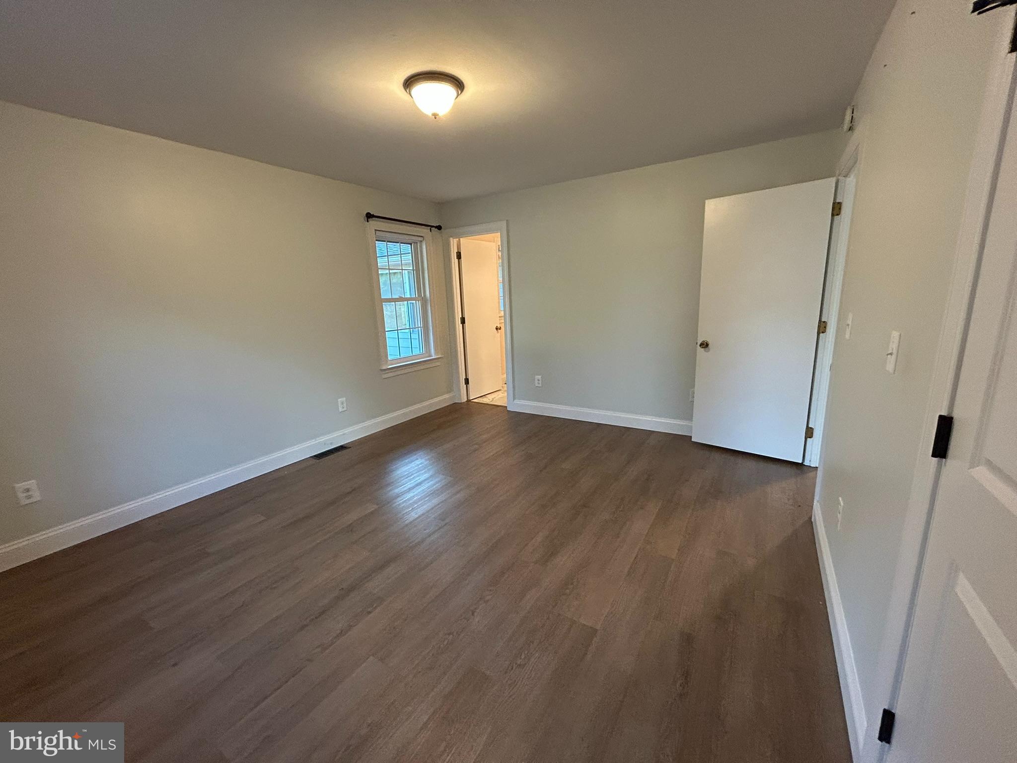 136 Cedar Knoll Road Coatesville, PA 19320 - Photo 17 of 28 an empty room with wooden floor and windows