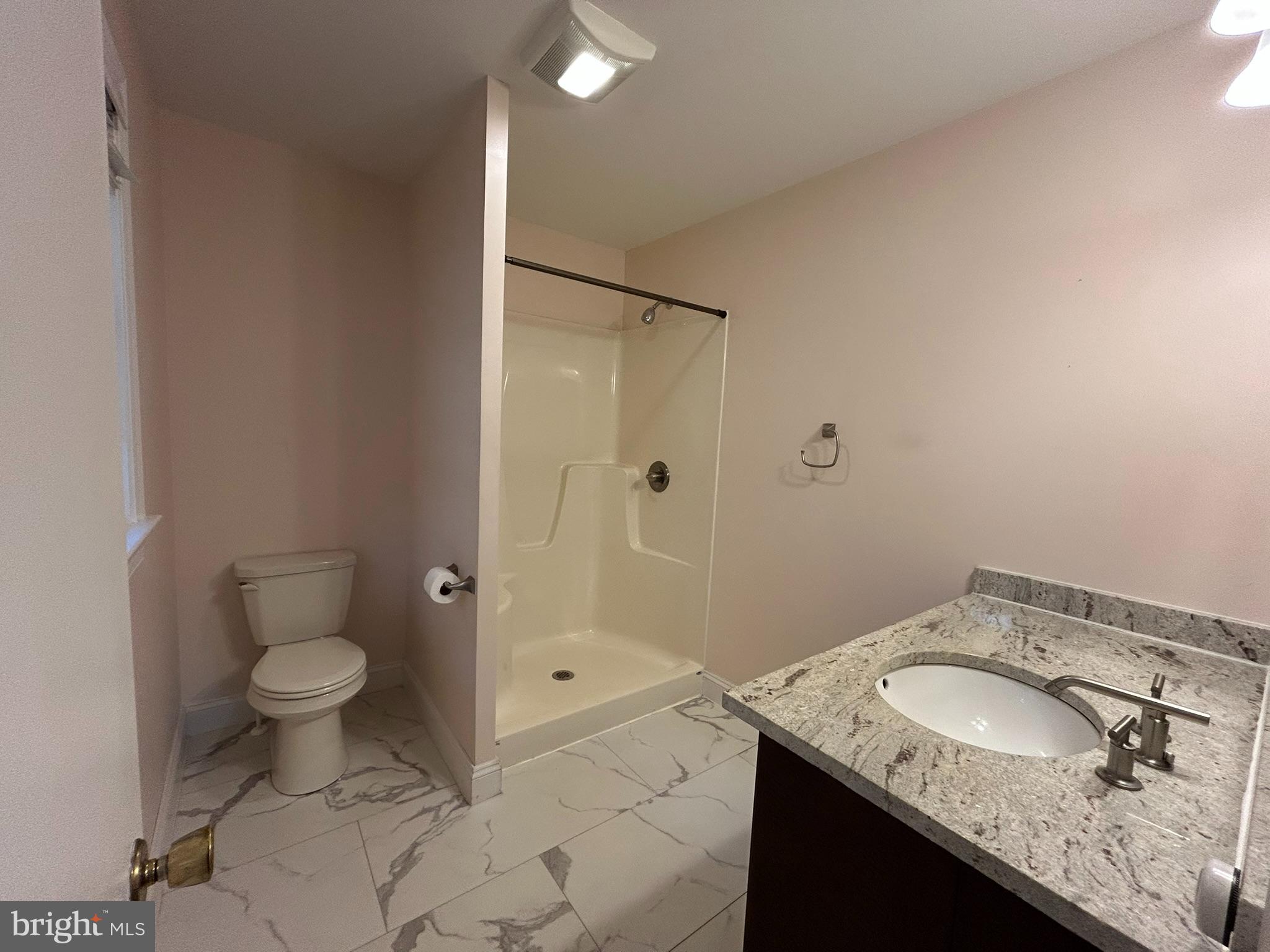 136 Cedar Knoll Road Coatesville, PA 19320 - Photo 18 of 28 a bathroom with a granite countertop sink a toilet and shower