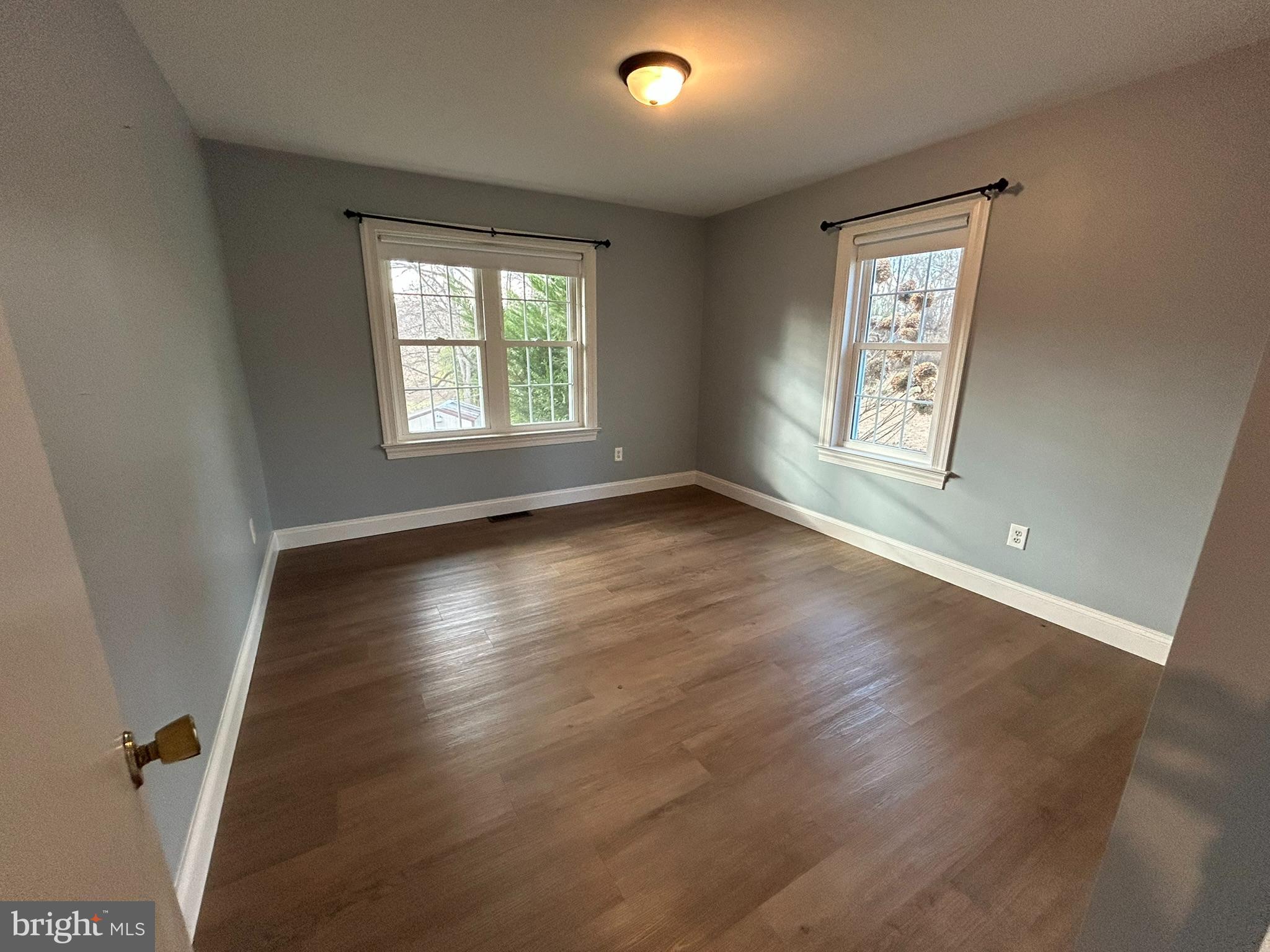 136 Cedar Knoll Road Coatesville, PA 19320 - Photo 19 of 28 a view of an empty room with wooden floor and a window
