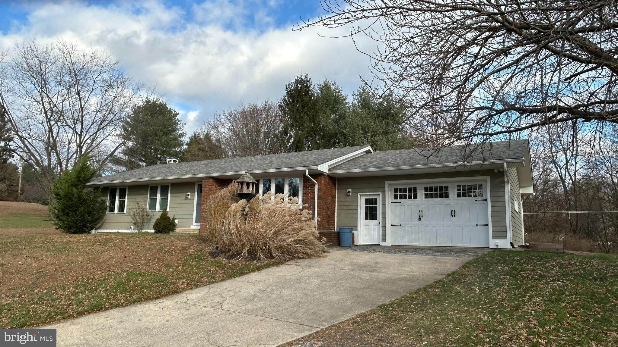 136 Cedar Knoll Road Coatesville, PA 19320 - Photo 3 of 28 front view of a house with a yard and an trees